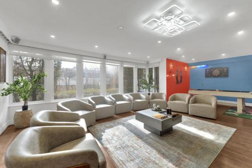 a large living room with couches and a pool table at Fire and Fun Luxe Stay w Pool Hot Tub and Game Room in Linden