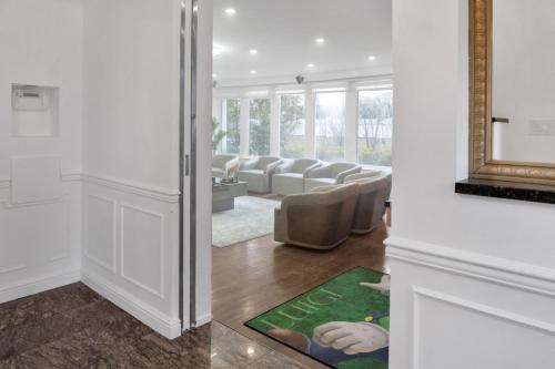 a living room with couches and a rug at Fire and Fun Luxe Stay w Pool Hot Tub and Game Room in Linden