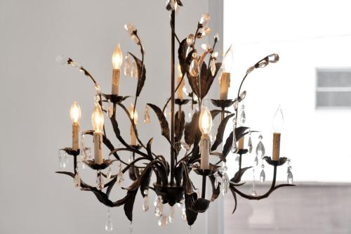 a chandelier with candles in a room at Fire and Fun Luxe Stay w Pool Hot Tub and Game Room in Linden