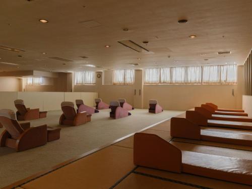 a lobby with chairs and a waiting room at Sagayamato Onsen Hotel Amandi in Saga