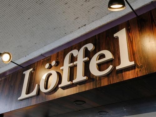 a sign for the loe on the wall of a store at Sagayamato Onsen Hotel Amandi in Saga