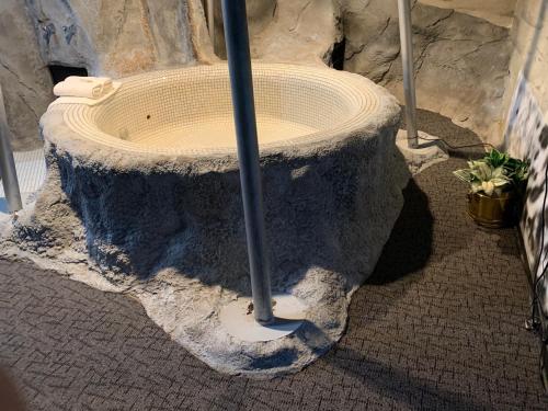 a bird bath with an umbrella in the corner at Don Q Inn in Dodgeville