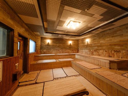 an empty sauna with wooden walls and ceilings at Sagayamato Onsen Hotel Amandi in Saga