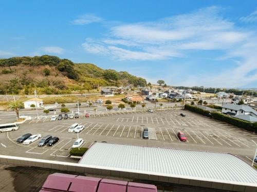 a parking lot with cars parked in it at Sagayamato Onsen Hotel Amandi in Saga