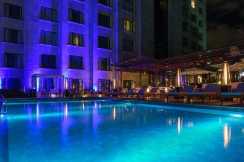 a swimming pool in front of a building at night at Intercontinental Real Guatemala by IHG in Guatemala