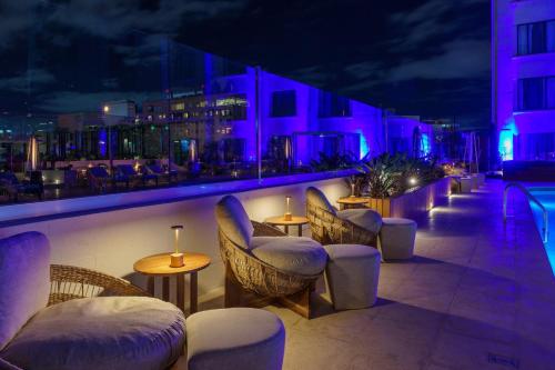 a bar with chairs and tables and purple lights at Intercontinental Real Guatemala by IHG in Guatemala