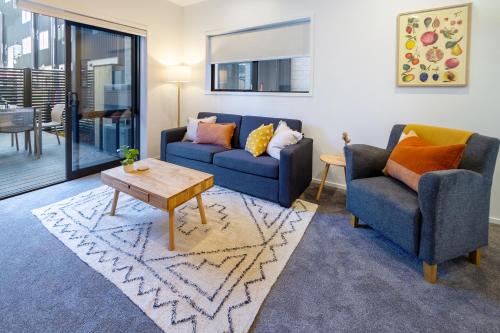 a living room with two couches and a coffee table at Tuam Street delight 4 bed 4 bath with Carpark in Christchurch
