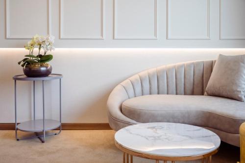 a living room with a couch and a table at Grabel Hotel Jeju in Jeju