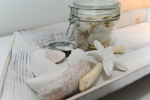 a mason jar filled with rocks and a jar of sand at Hüs in`t Dörp in Oevenum