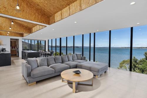 a living room with a large couch and a table at Stylish Home with Outdoor Area & Spectacular Views in Penna