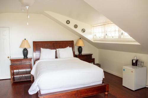 a bedroom with a white bed and a staircase at Banning House of Two Harbors in Two Harbors