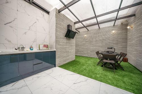 a room with a table and a green lawn at Hotel MARIA in Pyeongtaek