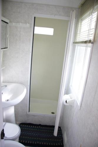 a bathroom with a shower and a toilet and a sink at Camping Klaus in Cavallino-Treporti