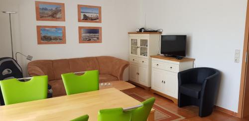 a living room with a couch and a table and chairs at Ostseeglück App9 in Zingst