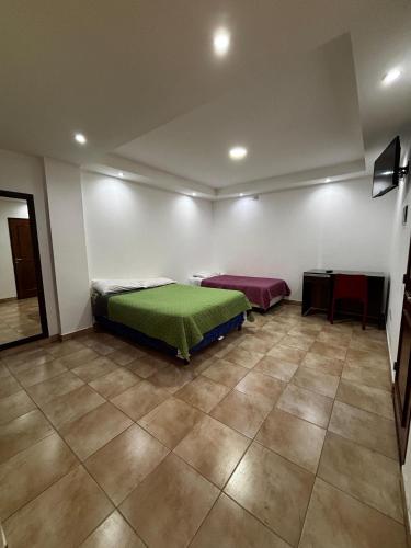 Postel nebo postele na pokoji v ubytování Hostal Monterrico