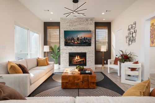a living room with a couch and a fireplace at Thompson Luxuries 4BR Modern Townhome in Rice Military in Houston