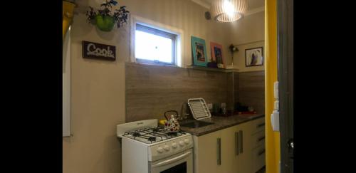 a small kitchen with a stove and a window at Dreams in La Plata
