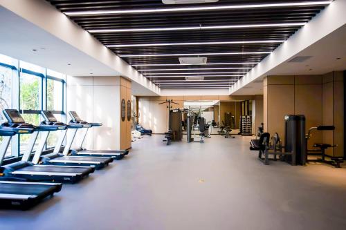 a gym with rows of treadmills and exercising machines at Citadines Science City Guangzhou-Shuttle bus to Canton Fair Complex during Canton Fair period in Guangzhou
