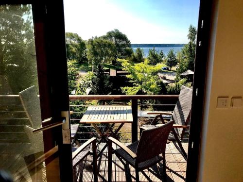 a balcony with two chairs and a table with a view at Stausee-Haus in Neumühle