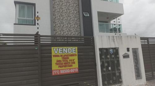a sign on a fence in front of a building at Apartment in Bessa One in João Pessoa