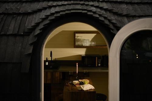 an archway in a kitchen with a table and a candle at The Forest at Mount Congreve Gardens in Kilmeaden