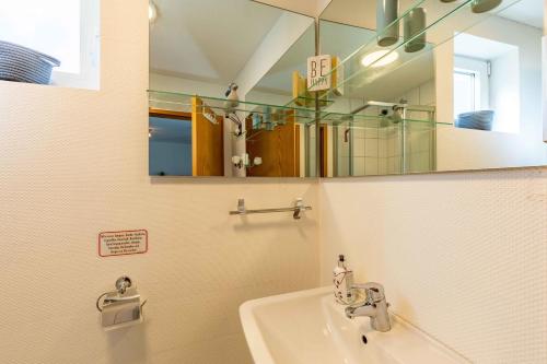 a bathroom with a sink and a mirror at Haus zum Seiltänzer - Leuchtturm in Eckernförde