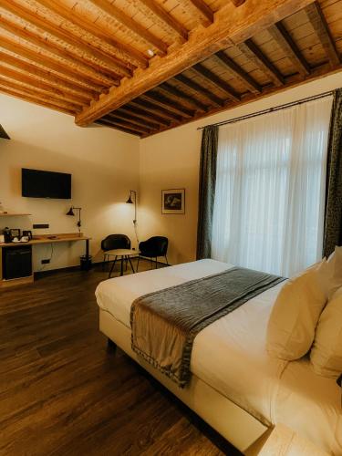 a bedroom with a large bed with a window at Hotel Harmony in Ghent