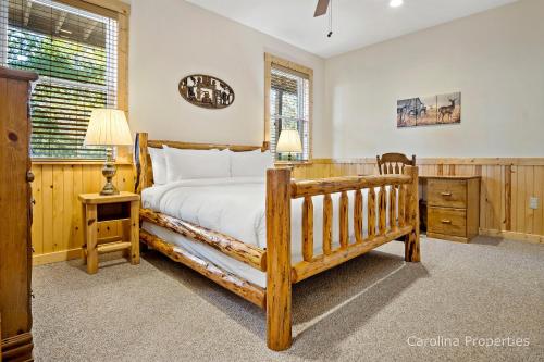 a bedroom with a wooden bed and a wooden dresser at Cedar Ridge in Mill Spring