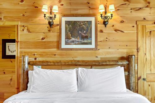 a bedroom with wooden walls and a bed with white pillows at Cedar Ridge in Mill Spring