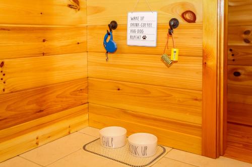 a room with a wooden wall with two stools at Cedar Ridge in Mill Spring