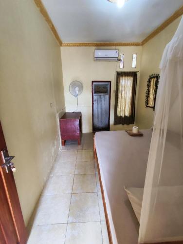 a hallway with a room with a table and a desk at FRANGKY HOMESTAY in Manado
