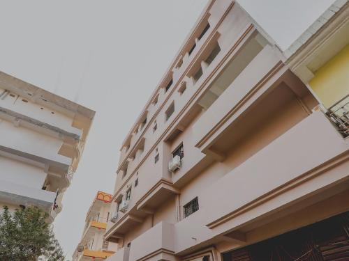 a building with a clock on the side of it at Hotel Navya Grand in Patna