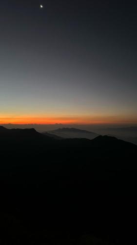 a view of the sunset from the top of a mountain at Green House in Adams Peak