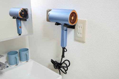 a blue light on top of a toilet in a bathroom at 瑠璃色の地球 in Katsuura