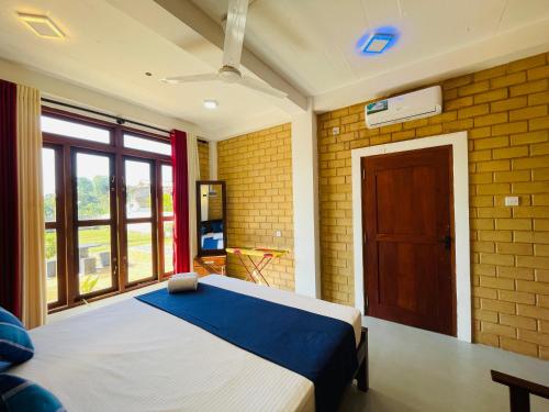 a bedroom with a bed and a large window at CDR Eco Home in Weligama