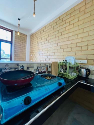 a kitchen counter with a bowl on top of a stove at CDR Eco Home in Weligama