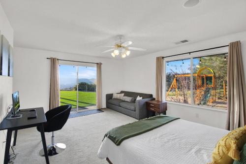 a bedroom with a bed and a couch and a window at Yosemite Vista Highlands in Oakhurst