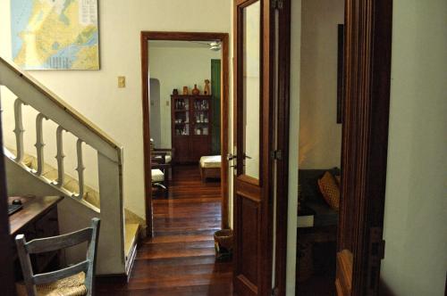 a hallway with a stairway leading to a living room at Pousada Baluarte in Salvador