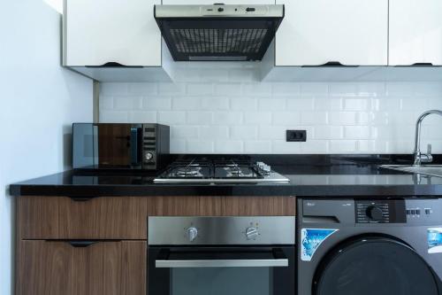 Kuchyň nebo kuchyňský kout v ubytování Appartement Prestige et Confort