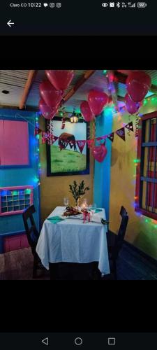 a dining room with a table with balloons on it at DESCANSO DEL ARRIERO - Su Mejor Descanso en Guatapé in Guatapé