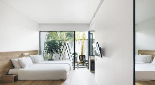a bedroom with two beds and a couch at Lloyd's Inn in Singapore