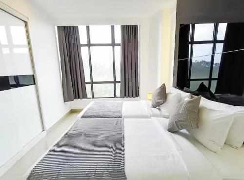a large white bed in a room with windows at Grand Ion Genting Highlands in Genting Highlands