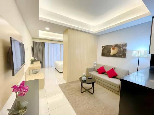 a living room with a couch and a tv at Grand Ion Genting Highlands in Genting Highlands