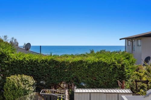 a view of the ocean from a house at Sunny Daze - Ohope Beach Holiday Home in Ohope Beach