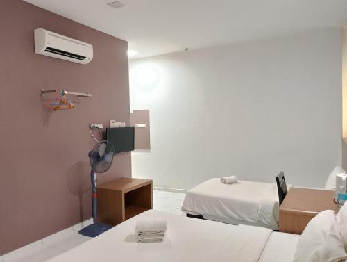 Postel nebo postele na pokoji v ubytování Hotel Wawasan