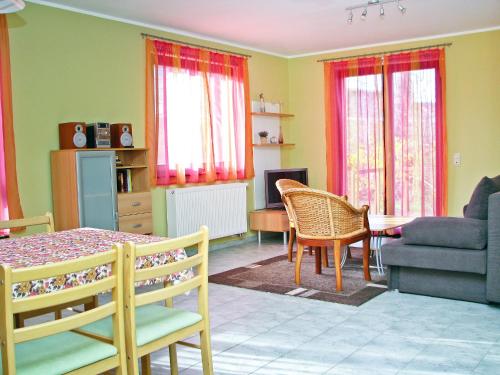 a living room with a couch and a table and chairs at Hütigendachs, FW 4 in Zingst