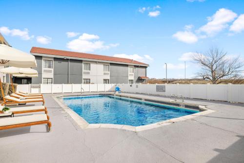 a swimming pool in front of a building at Spark by Hilton Rock Springs in Rock Springs