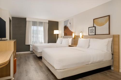 a hotel room with two beds and a television at Spark by Hilton Rock Springs in Rock Springs