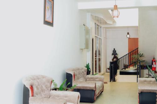 a living room with two chairs and a couch at Hidden Gem Yala in Tissamaharama