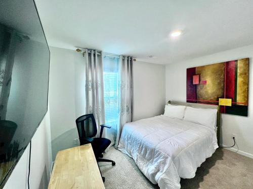 a small bedroom with a bed and a desk at Spacious 4-bedroom house,6beds with office space in Charlotte